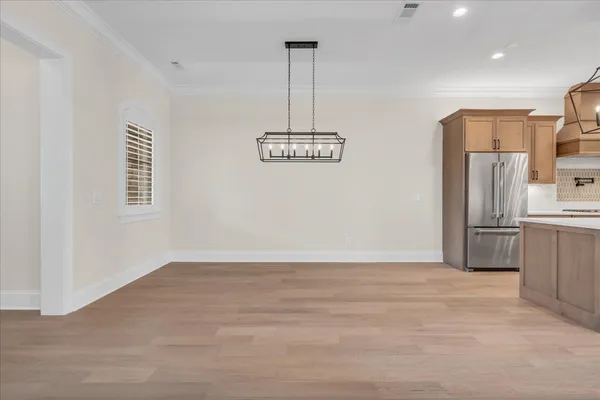 a view of an empty room with furniture and a window