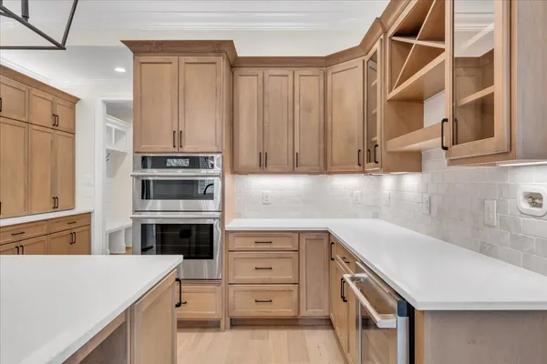 an empty room with wooden floor and ceiling fan