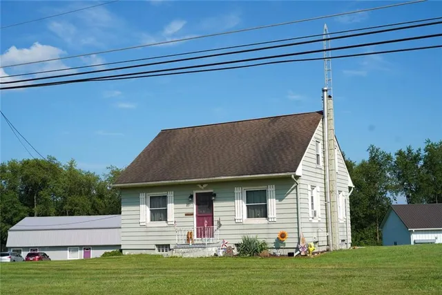 a front view of a house with a garden