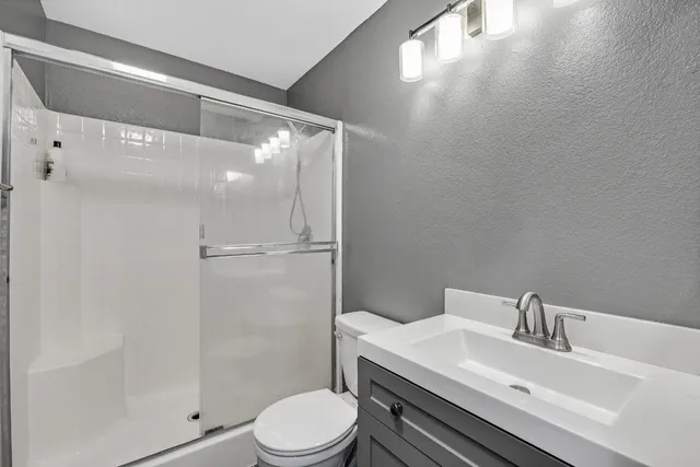 a white toilet sitting next to a bathroom sink
