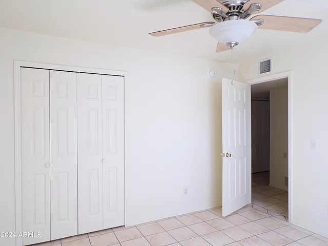 a view of a room with a ceiling fan