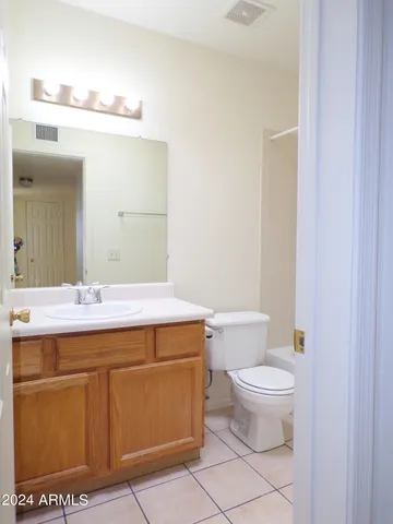 a bathroom with a sink a toilet and mirror