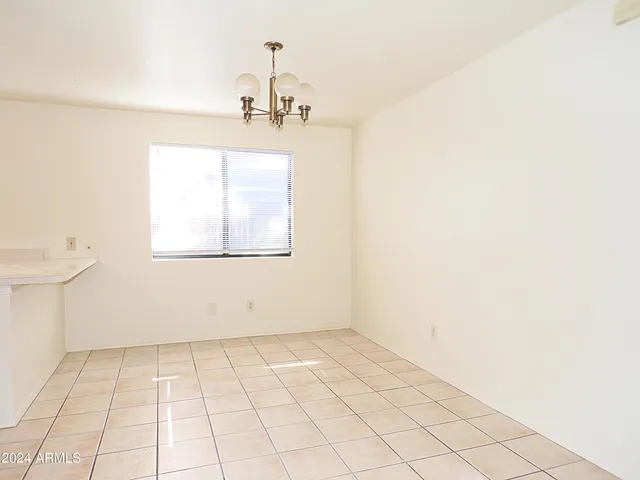 a view of a room with white walls and tiles