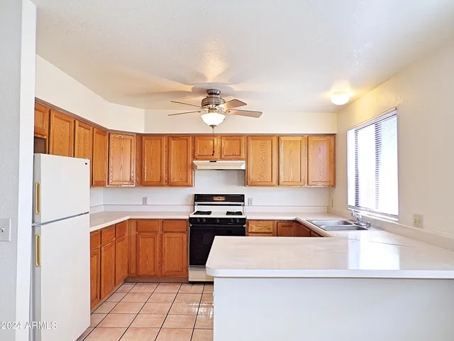 a kitchen with a stove a refrigerator and a sink