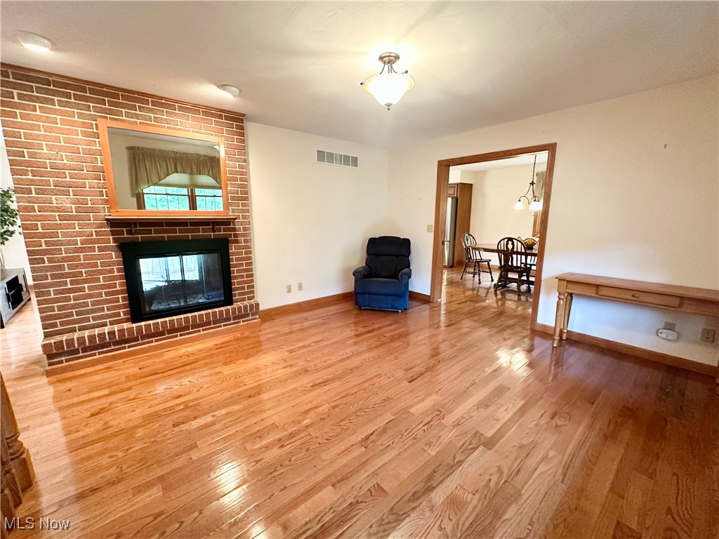 4461 Cross Creek Road Colliers, WV 26035 - Photo 3 of 33 Living room with light wood-style floors and a fireplace