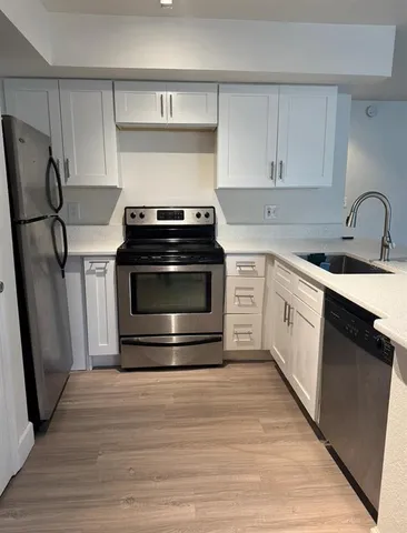 a kitchen with a stove and a refrigerator