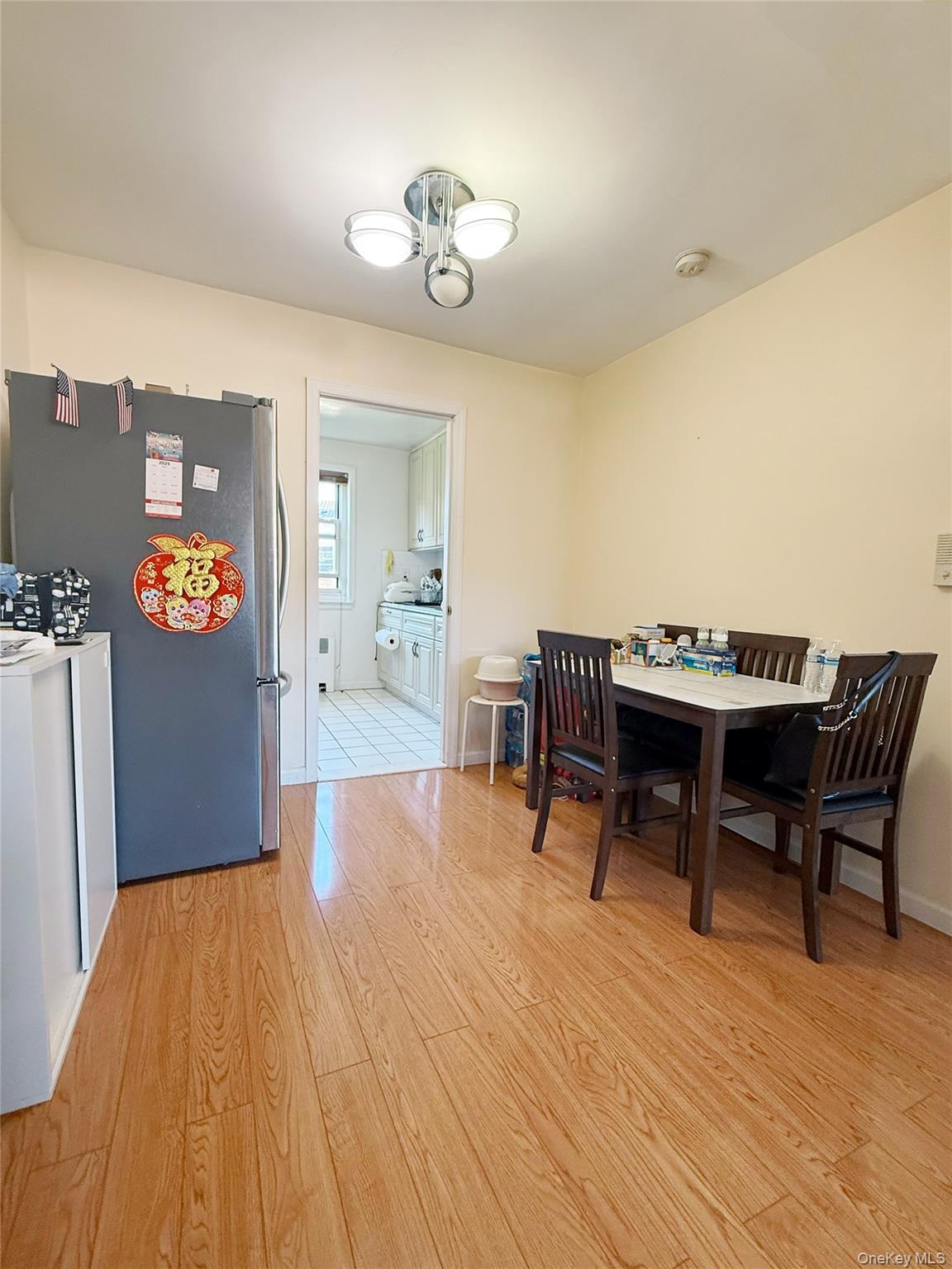 152-47 Jewel Avenue, Unit 159B Queens, NY 11367 - Photo 3 of 11 a view of a dining room with furniture and wooden floor