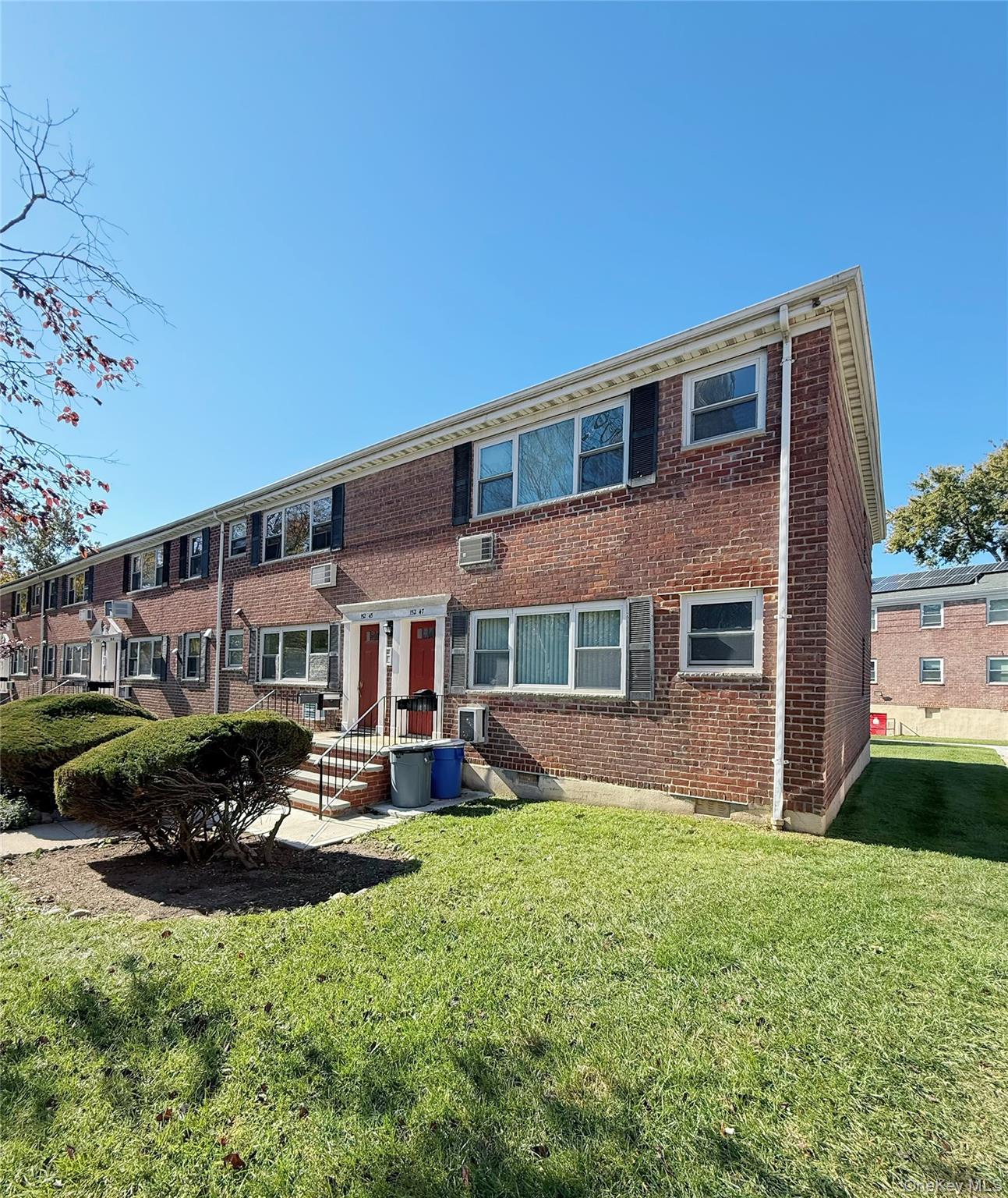 152-47 Jewel Avenue, Unit 159B Queens, NY 11367 - Photo 7 of 11 a front view of a house with a yard table and chairs