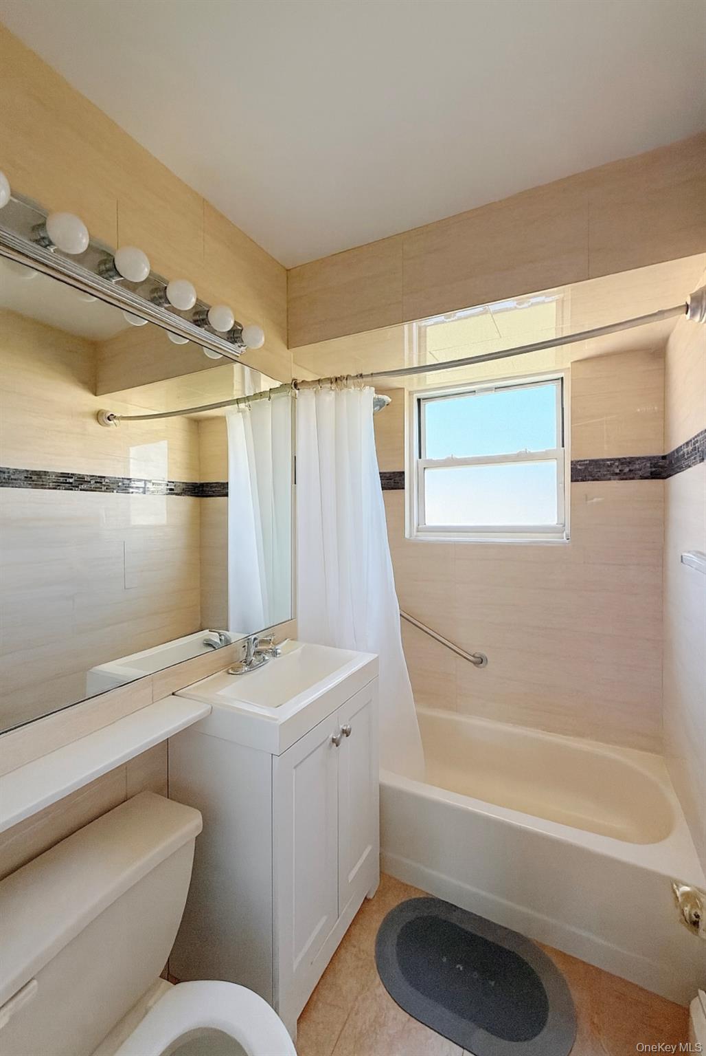 152-47 Jewel Avenue, Unit 159B Queens, NY 11367 - Photo 9 of 11 a bathroom with a sink a toilet and shower