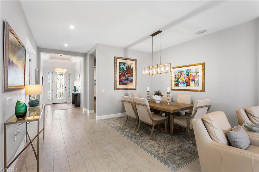 15216 Turin Drive Naples, FL 34114 - Photo 15 of 50 Dining space featuring hanging lights and light wood-style flooring