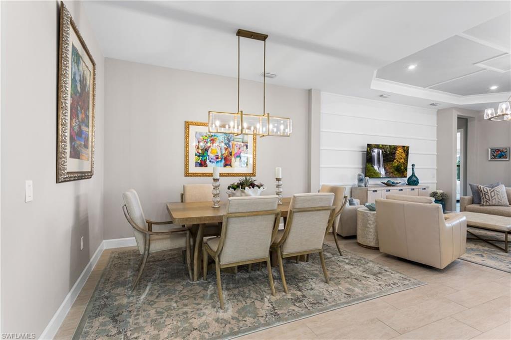 15216 Turin Drive Naples, FL 34114 - Photo 16 of 50 Dining area with hanging lights and a tray ceiling