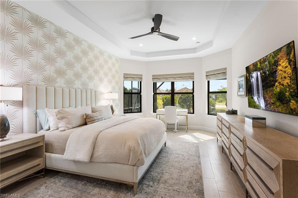 15216 Turin Drive Naples, FL 34114 - Photo 17 of 50 Bedroom with ceiling fan, a tray ceiling, wood finished floors, and an office area