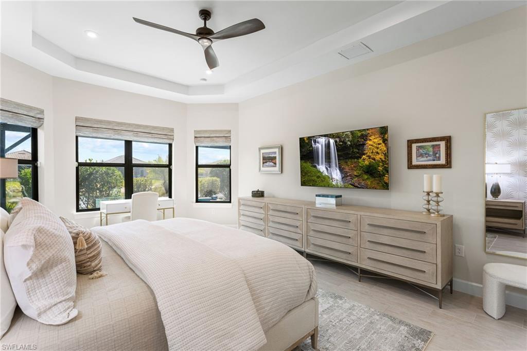 15216 Turin Drive Naples, FL 34114 - Photo 18 of 50 Bedroom featuring a tray ceiling, ceiling fan, light wood-type flooring, and recessed lighting