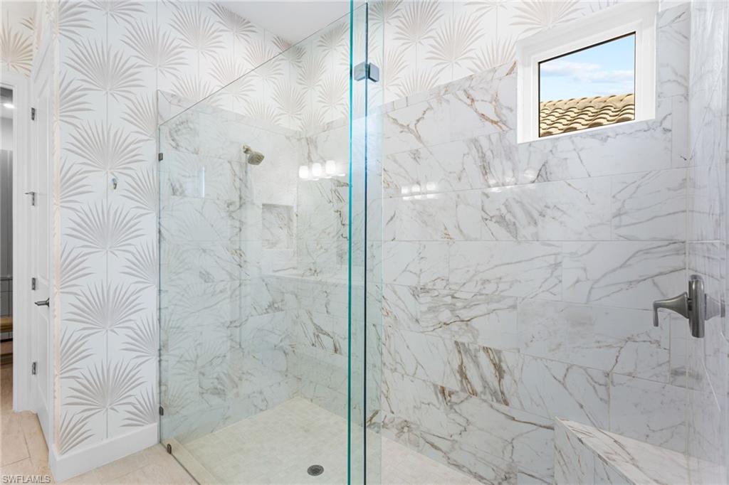 15216 Turin Drive Naples, FL 34114 - Photo 20 of 50 Bathroom with a marble finish shower and wallpapered walls