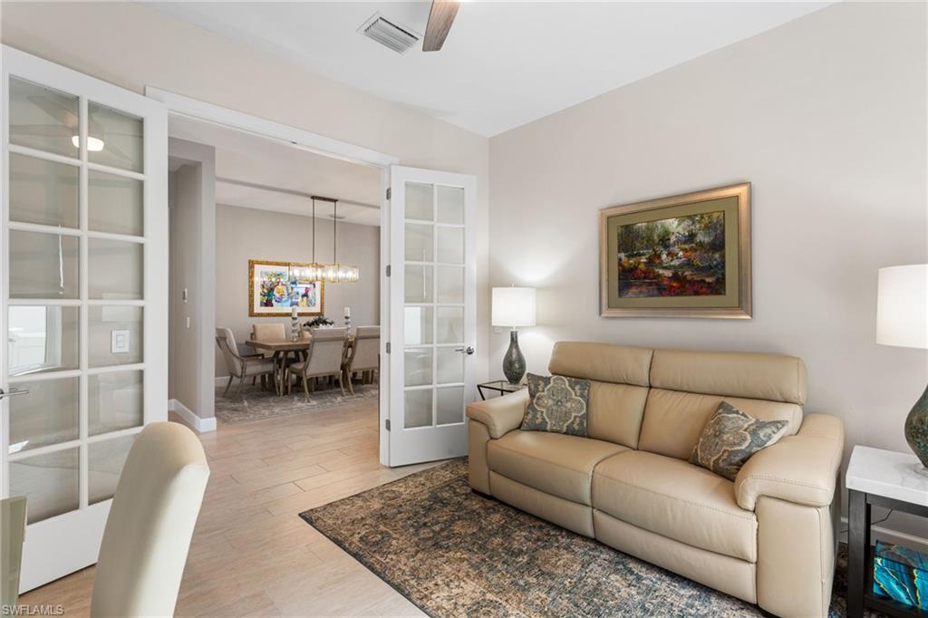 15216 Turin Drive Naples, FL 34114 - Photo 22 of 50 Living room with light wood finished floors, a ceiling fan, and french doors