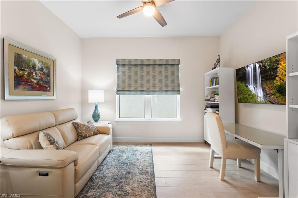 15216 Turin Drive Naples, FL 34114 - Photo 23 of 50 Living room featuring ceiling fan, a desk, and light wood finished floors