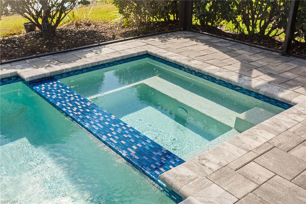 15216 Turin Drive Naples, FL 34114 - Photo 36 of 50 View of pool featuring an in-ground hot tub and patio surround