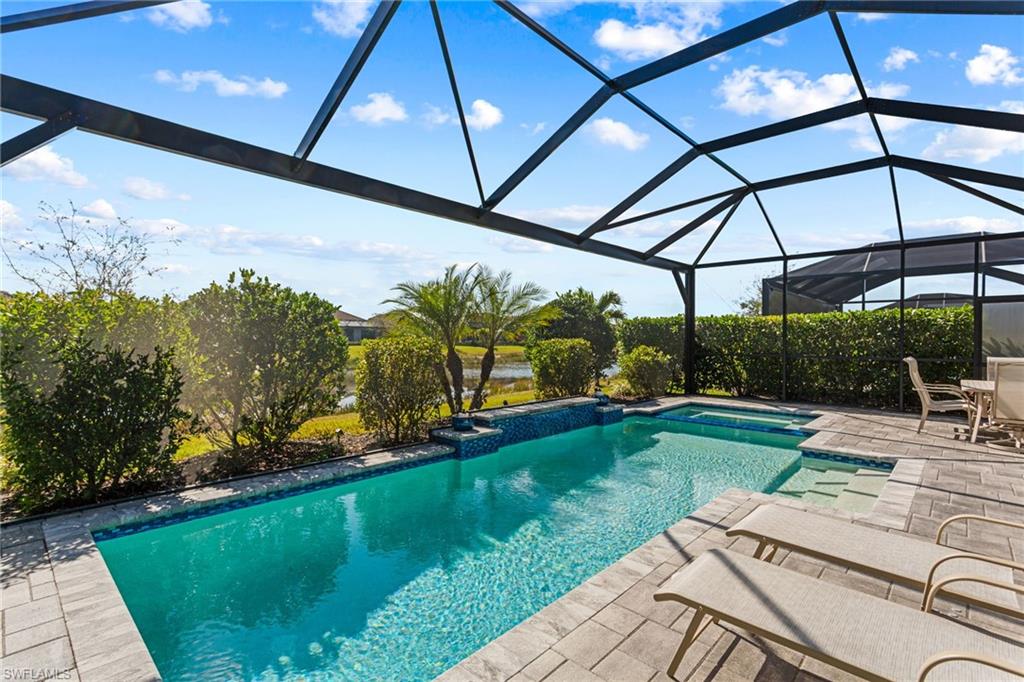15216 Turin Drive Naples, FL 34114 - Photo 37 of 50 Integrated pool / spa with a lanai, a sunroom, and a patio area