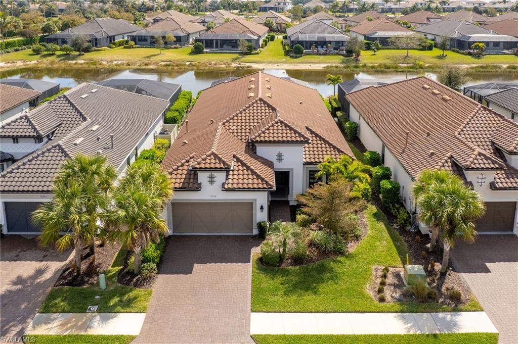 15216 Turin Drive Naples, FL 34114 - Photo 42 of 50 Aerial view of residential area with a large body of water