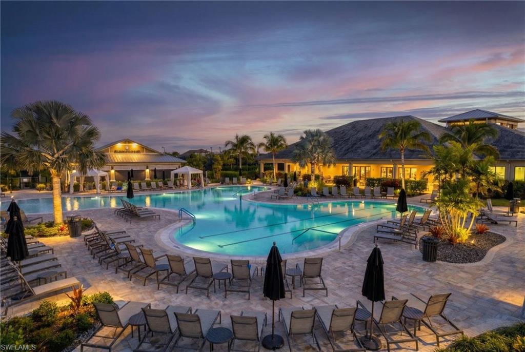 15216 Turin Drive Naples, FL 34114 - Photo 46 of 50 Pool at dusk with a community pool and a patio