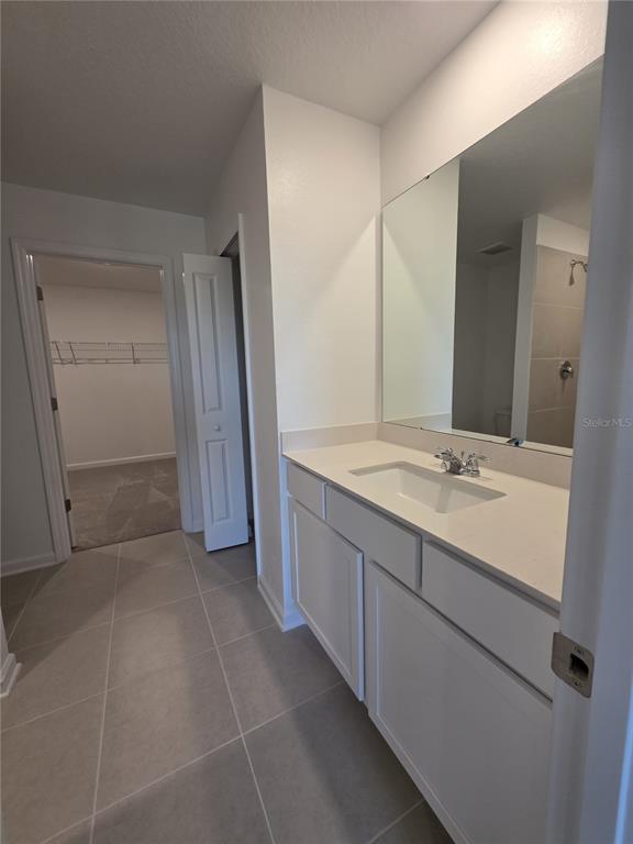3484 Chinotto Drive Lake Alfred, FL 33850 - Photo 19 of 32 a bathroom with a double vanity sink and mirror