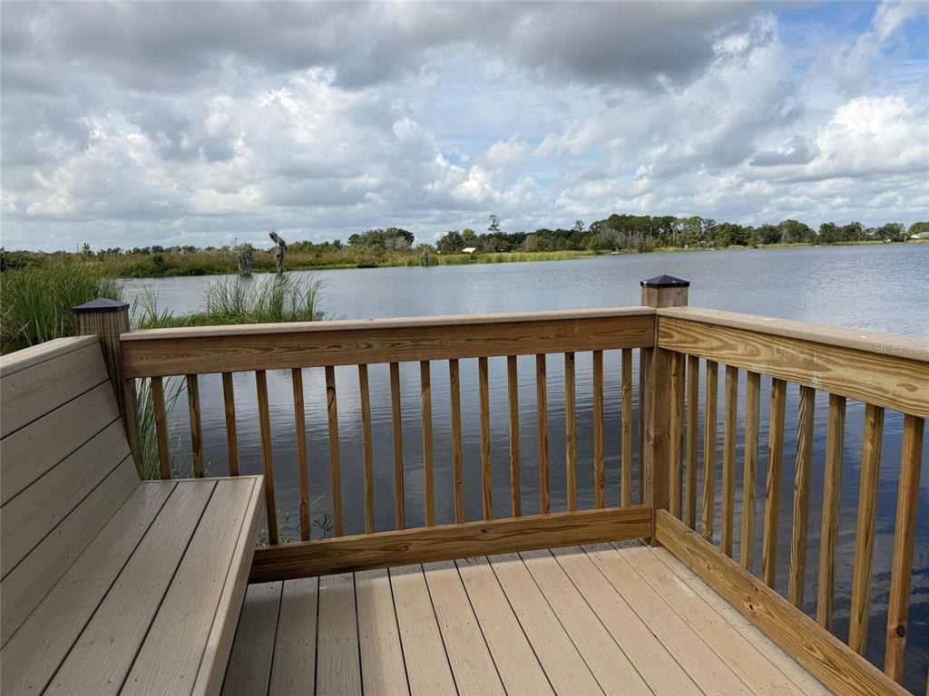 3484 Chinotto Drive Lake Alfred, FL 33850 - Photo 29 of 32 a balcony with wooden floor and lake view