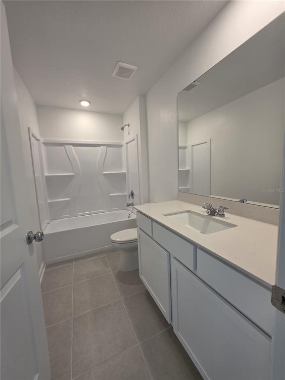 3484 Chinotto Drive Lake Alfred, FL 33850 - Photo 5 of 32 a bathroom with a granite countertop sink a toilet and shower