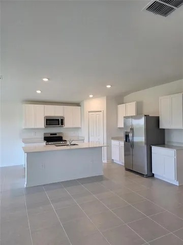 a kitchen with stainless steel appliances a refrigerator sink and stove