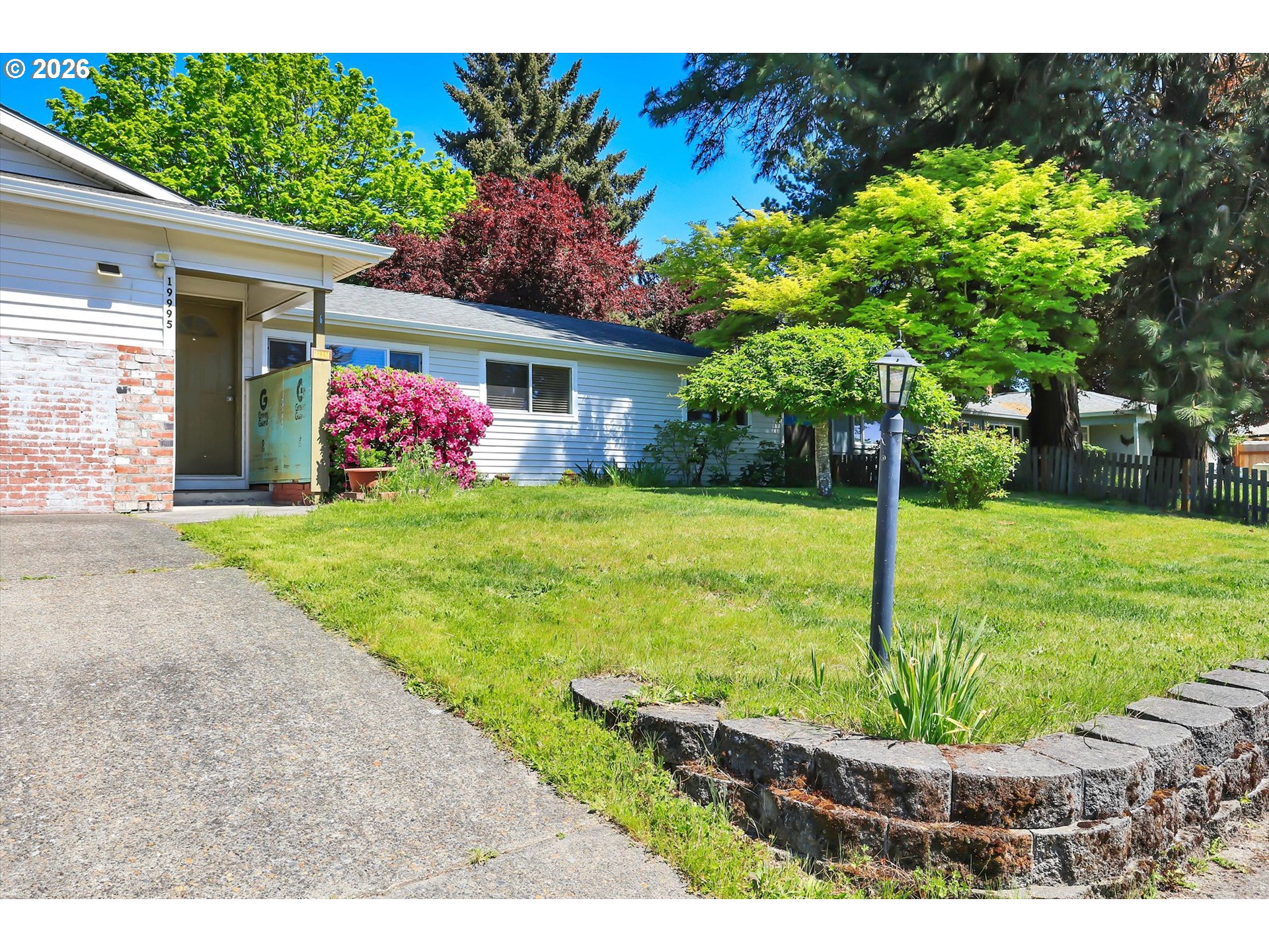19995 Southwest York Street Beaverton, OR 97003 - Photo 1 of 37 a front view of a house with garden