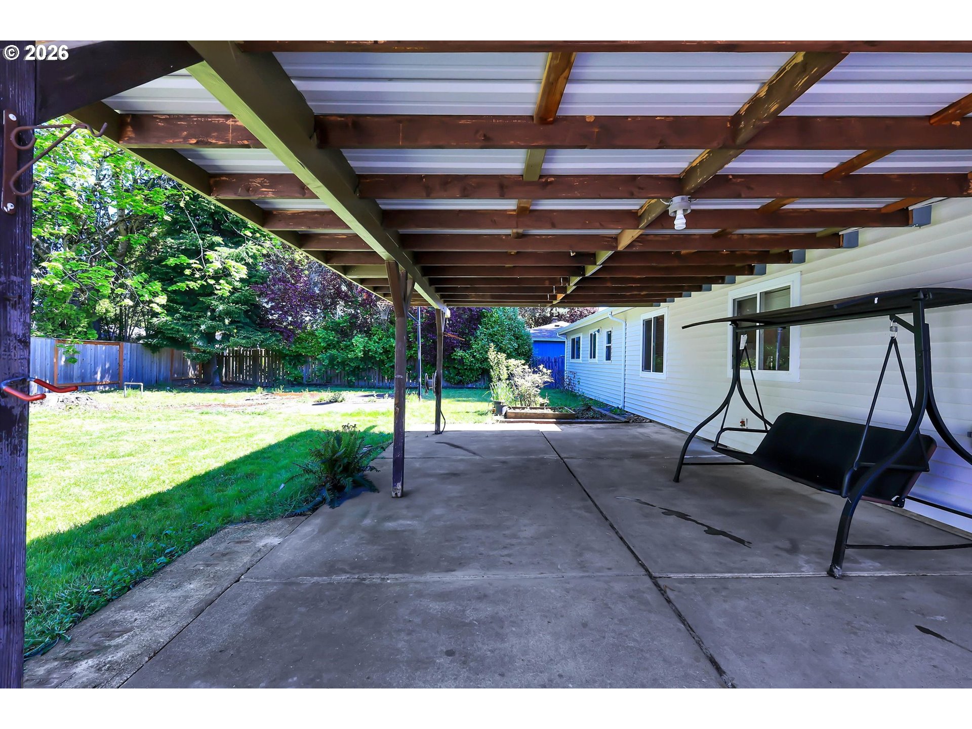19995 Southwest York Street Beaverton, OR 97003 - Photo 31 of 37 a view of a backyard with table and chairs under an umbrella