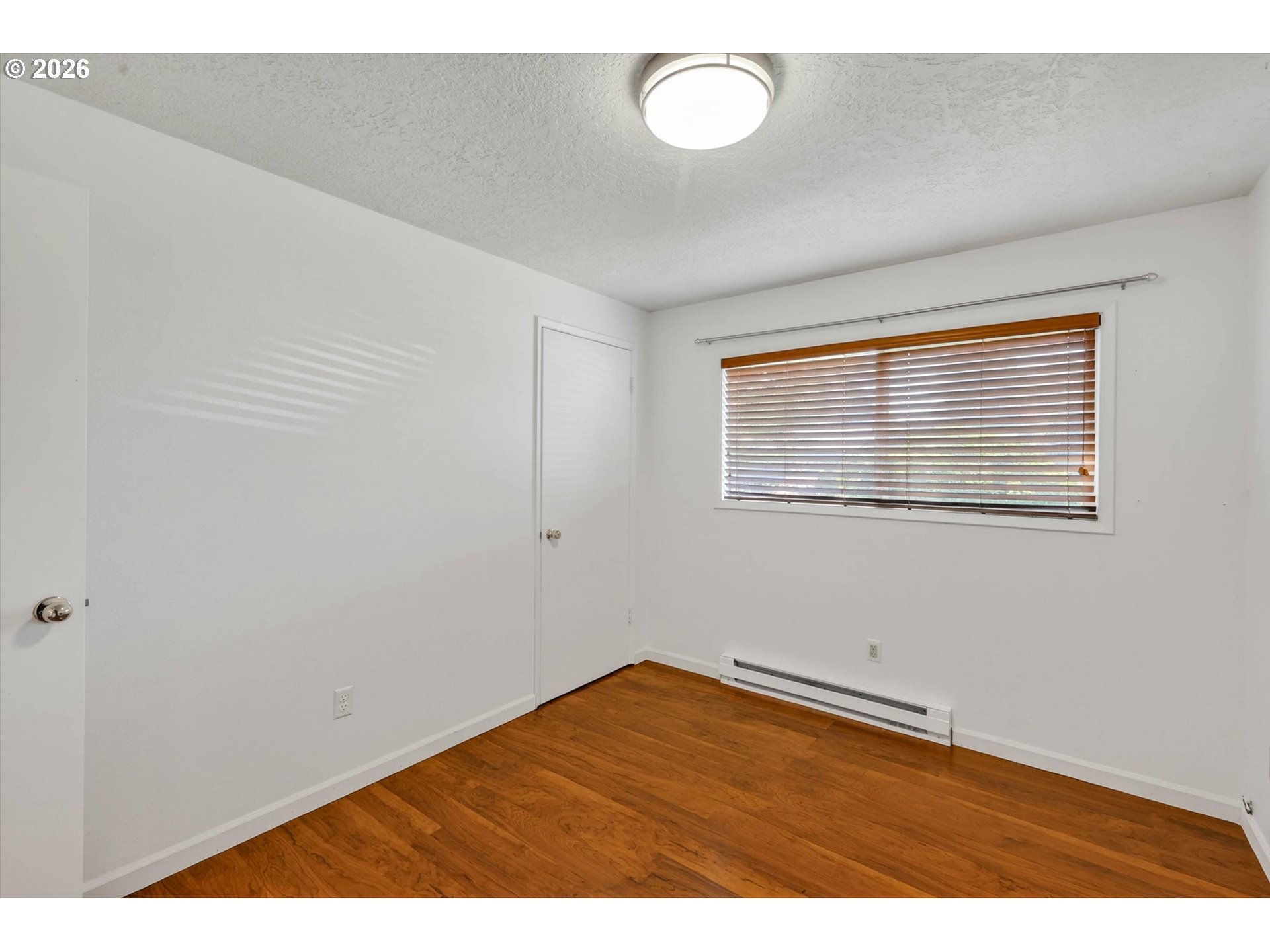 19995 Southwest York Street Beaverton, OR 97003 - Photo 8 of 37 a view of an empty room with wooden floor and a window