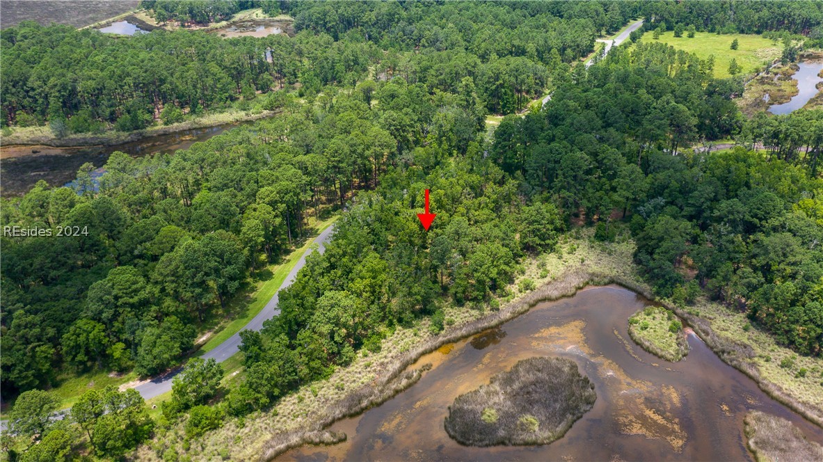 859 Bridle Path Boulevard Hardeeville, SC 29927 - Photo 22 of 40 Aerial view of Lot 27 and the magnificent water/marsh views beyond and Savannah in the distance. This pond was once part of the historic rice fields of the south. Now it is a place to observe resident shore birds and stunning sunrises to the east.