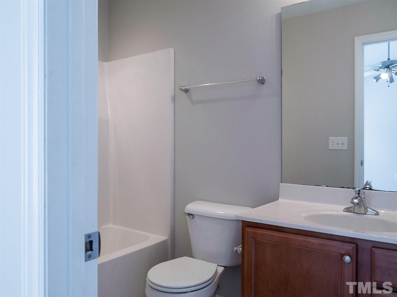 2120 Piney Brook Road, Unit 103 Raleigh, NC 27614 - Photo 22 of 22 a bathroom with a sink a toilet and shower