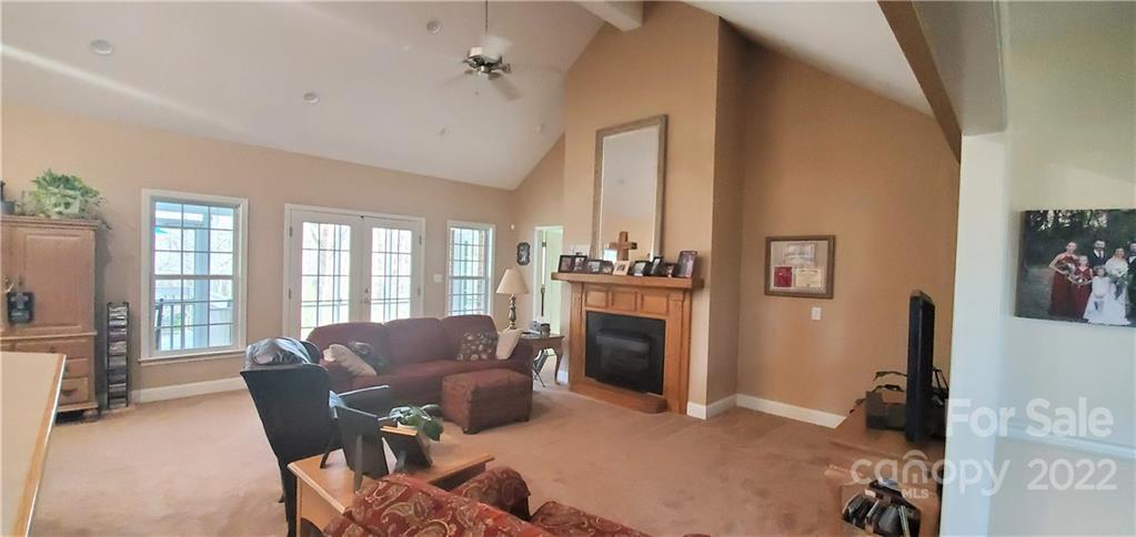 1820 Daisy Couch Road Heath Springs, SC 29058 - Photo 7 of 21 a living room with furniture a fireplace and a flat screen tv