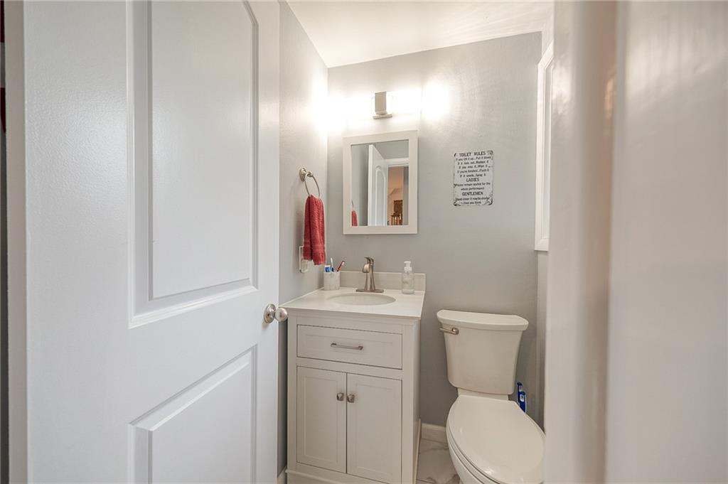 1004 Fiddleback Drive McKees Rocks, PA 15136 - Photo 14 of 41 a bathroom with a toilet a sink and mirror