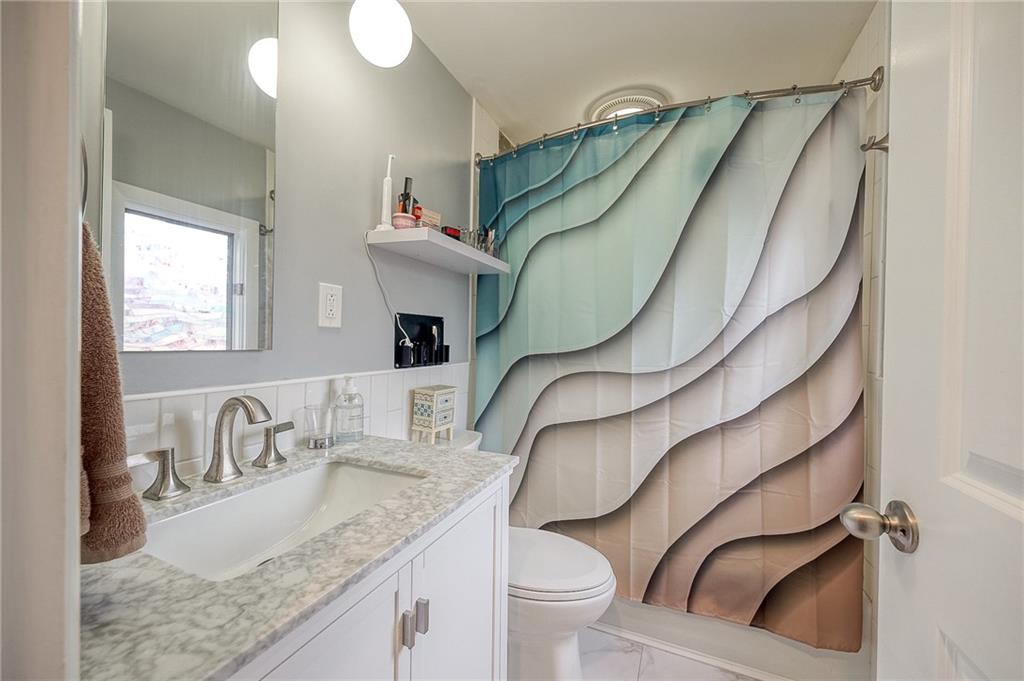 1004 Fiddleback Drive McKees Rocks, PA 15136 - Photo 20 of 41 a bathroom with a granite countertop sink a toilet and a mirror