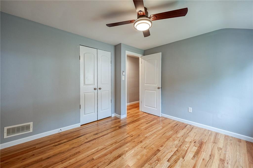 1004 Fiddleback Drive McKees Rocks, PA 15136 - Photo 25 of 41 an empty room with wooden floor fan and windows