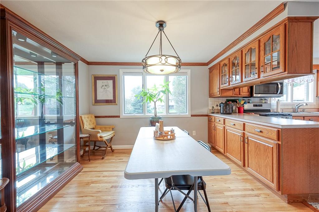 1004 Fiddleback Drive McKees Rocks, PA 15136 - Photo 6 of 41 a kitchen with stainless steel appliances granite countertop a stove a sink dishwasher and cabinets with wooden floor