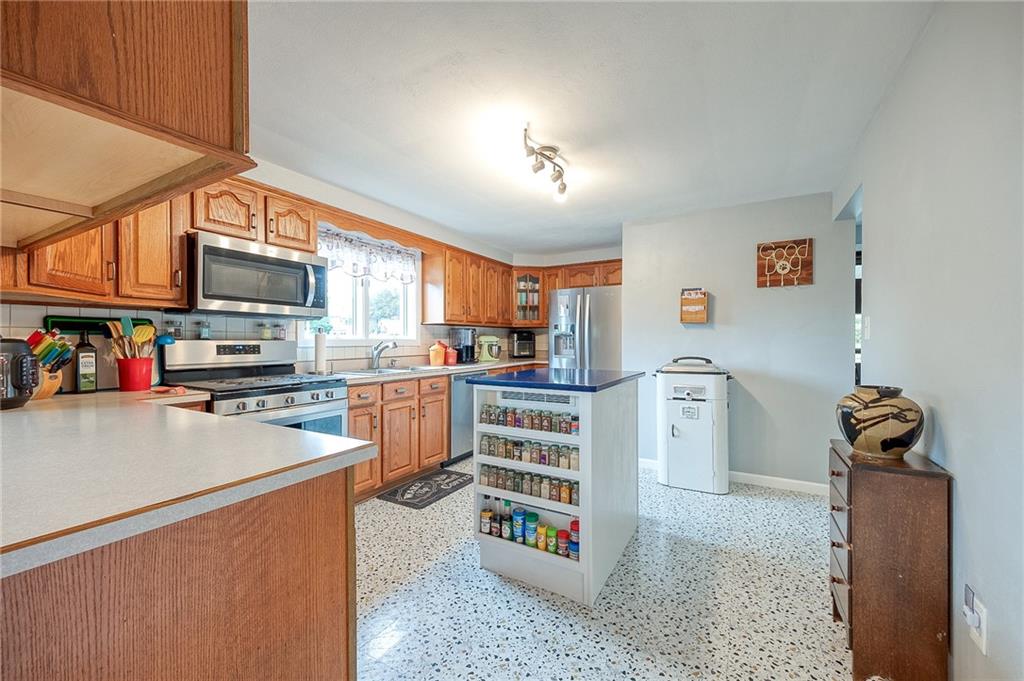 1004 Fiddleback Drive McKees Rocks, PA 15136 - Photo 9 of 41 a kitchen view with microwave a stove and cabinets