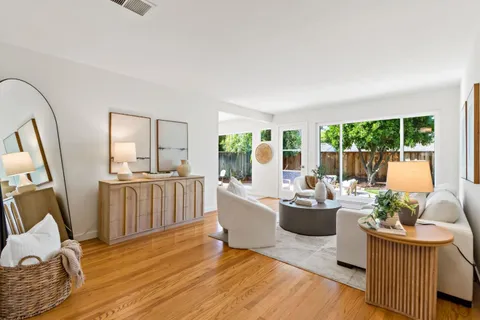 a room with kitchen island furniture and a wooden floor