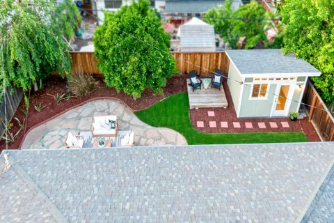 an aerial view of a house with a yard