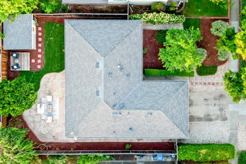 an aerial view of a house with a yard and garden