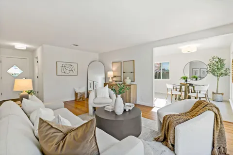 a living room with furniture and wooden floor