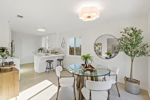 a living room with kitchen island furniture and a chandelier