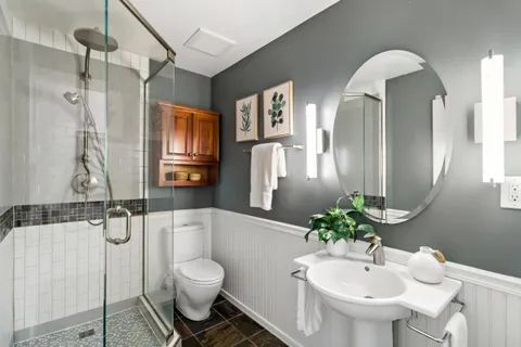 a bathroom with a toilet sink and shower
