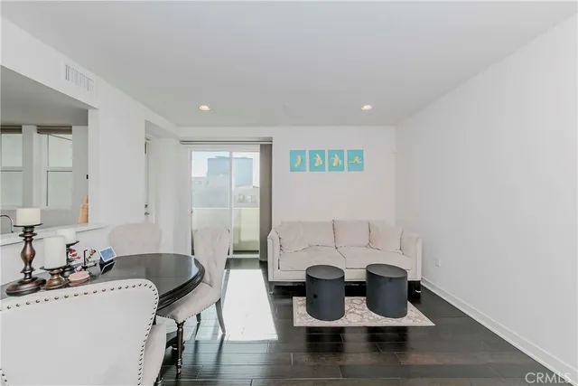 a dining room with furniture and wooden floor