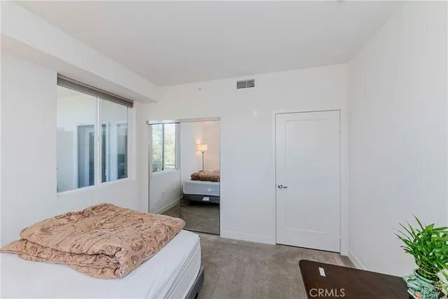 a bedroom with a bed and a chair