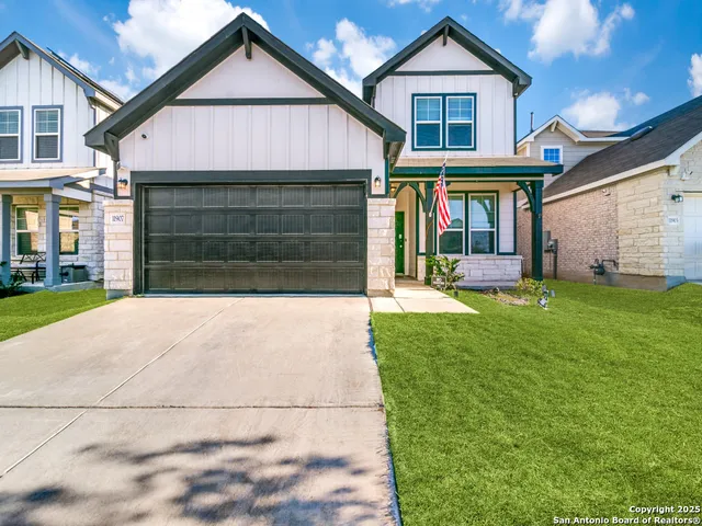 a front view of a house with a yard and garage
