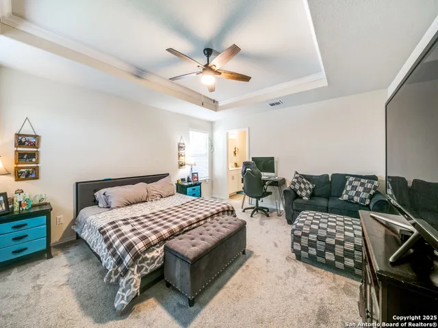 a bedroom with a bed and ceiling fan