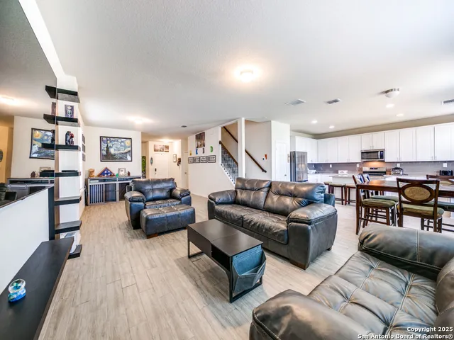 a living room with furniture and kitchen view